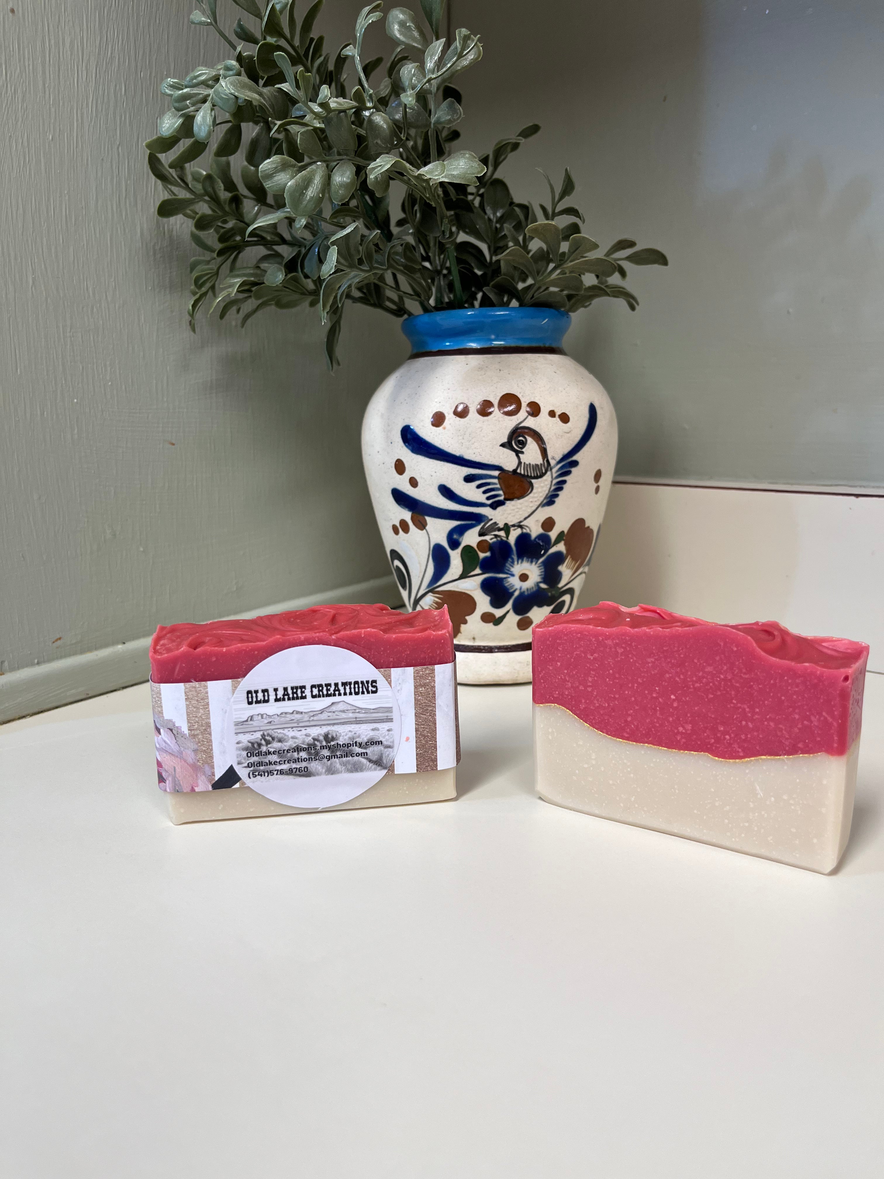 Cranberry Fig & Vanilla Apple Soap displayed beside a decorative vase, showcasing its vibrant colors and textures.
